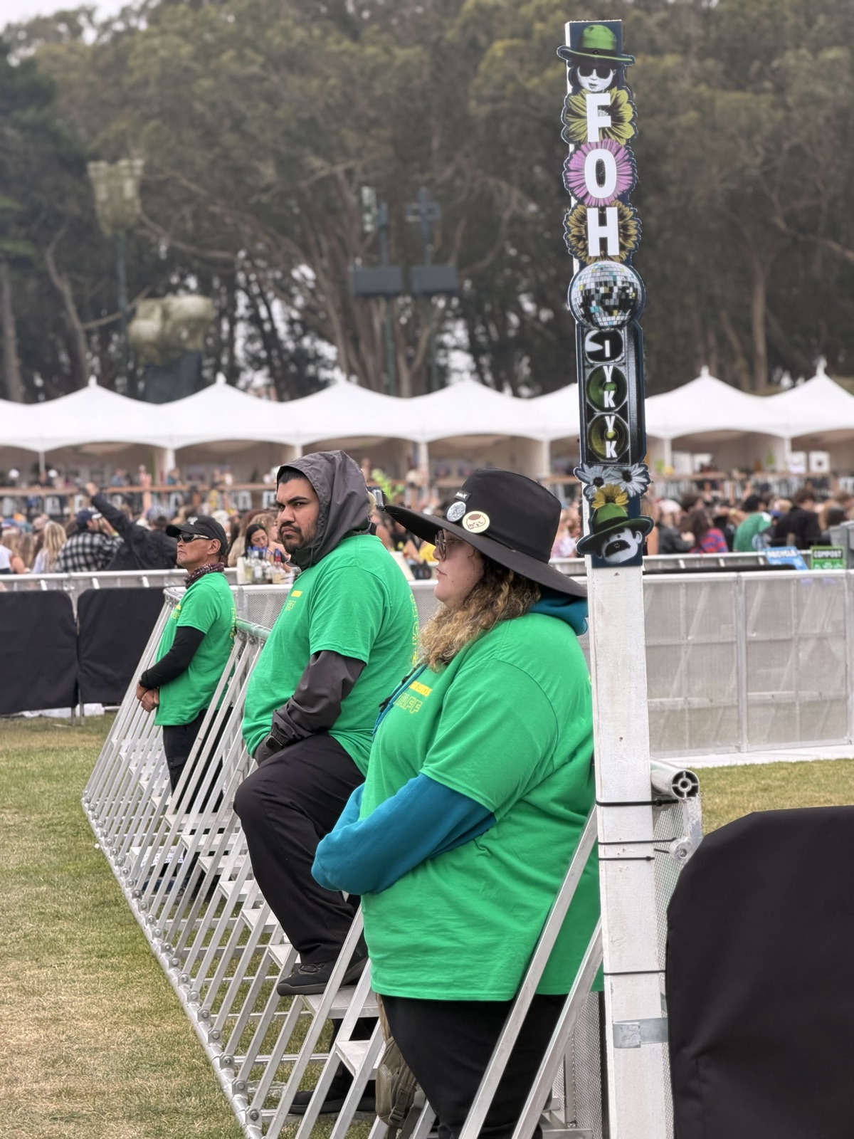 IEM event staff positioned along a festival access lane