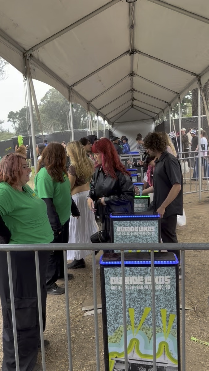 IEM staff assisting guests at illuminated festival entry gates